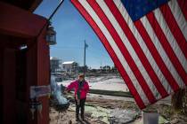 Paulina "Bela" Sebastiao lights a BBQ while waiting for her damaged house from Hurricane Michael to be torn down in Mexico Beach, Fla, Friday, Jan. 25, 2019. Since the storm destroyed th ...
