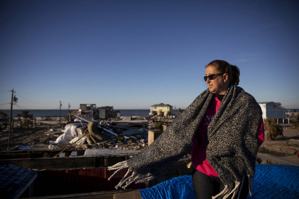Paulina "Bela" Sebastiao stands in what used to be her bedroom before her home is torn down that morning due to irreparable damage from Hurricane Michael in Mexico Beach, Fla, Friday, Ja ...