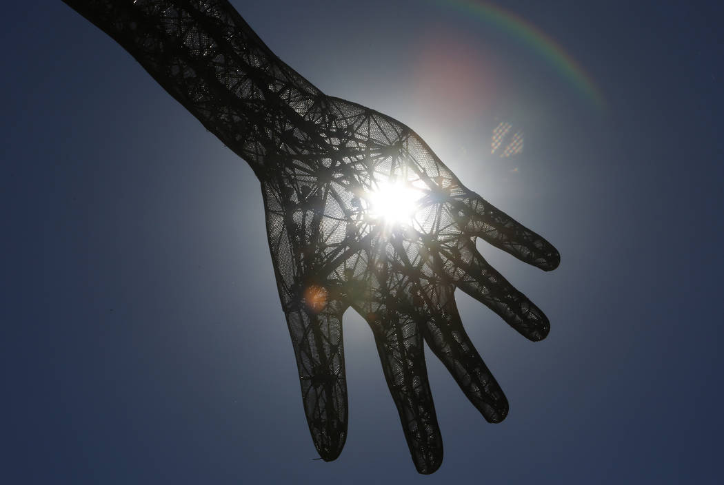 Sun rays pierce through the Bliss Dance sculpture at The Park near T-Mobile Arena on the Las Vegas Strip. (Bizuayehu Tesfaye/Las Vegas Review-Journal) @bizutesfaye