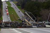 A fallen cell tower lies across U.S. Route 280 highway in Lee County, Ala., in the Smiths Station community after a tornado struck in the area Sunday, March 3, 2019. Severe storms destroyed mobile ...