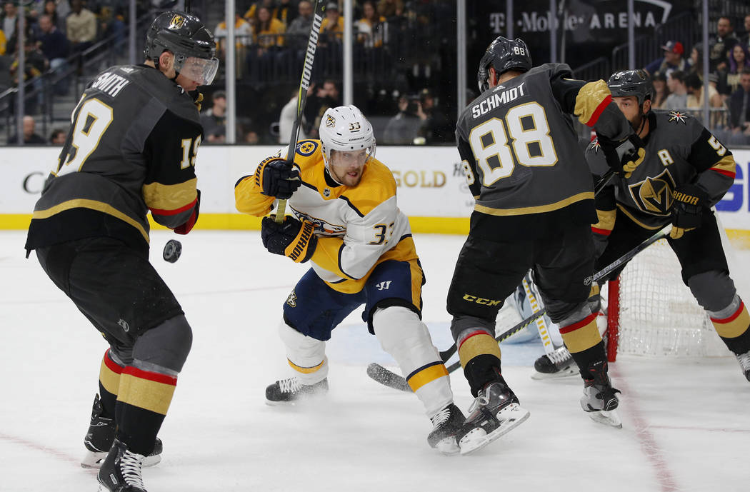 Vegas Golden Knights right wing Reilly Smith, Nashville Predators right wing Viktor Arvidsson, and Golden Knights defensemen Nate Schmidt and Deryk Engelland vie for the puck during the first peri ...