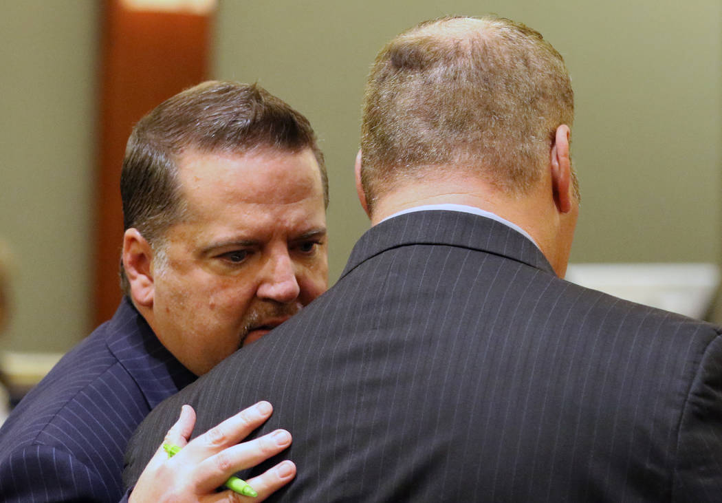 A former Las Vegas Fire Capt. Richard Loughry, 48, right, listens to his attorney Craig Hendricks at the Regional Justice Center on Monday, March 4, 2019, in Las Vegas. Loughry pleaded guilty to ...