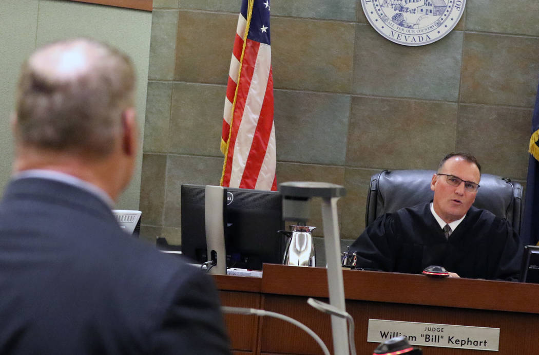 A former Las Vegas Fire Capt. Richard Loughry, 48, listens to District Judge William Kephart at the Regional Justice Center on Monday, March 4, 2019, in Las Vegas. Loughry pleaded guilty to two f ...