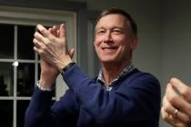In this Feb. 13, 2019, file photo, former Colorado Gov. John Hickenlooper, left, applauds at a campaign house party, in Manchester, N.H. Hickenlooper is running for president, becoming the second ...