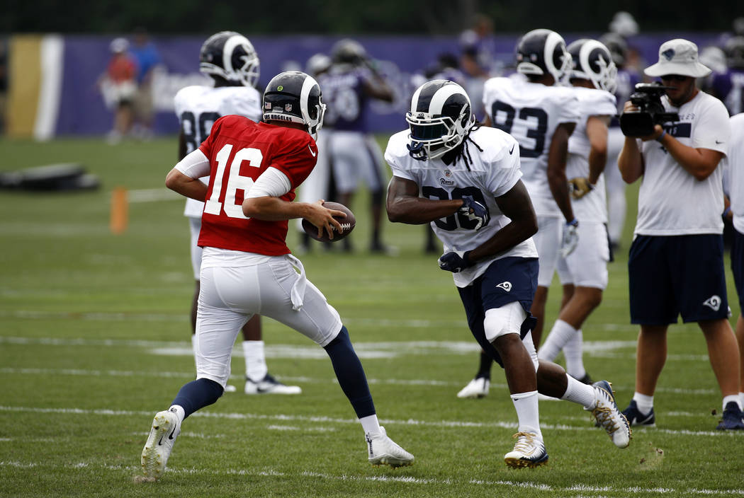 Los Angeles Rams running back Todd Gurley, right, runs a drill with quarterback Jared Goff during a joint NFL football training camp practice at the Baltimore Raven's headquarters, Tuesday, Aug. 7 ...