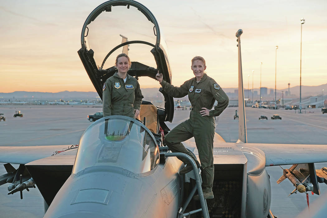 Marvel Studios' CAPTAIN MARVEL..Brie Larson (left) gets hands-on help from Brigadier General Jeannie Leavitt, 57th Wing Commander (right), on a recent trip to Nellis Air Force Base in Nevada to re ...