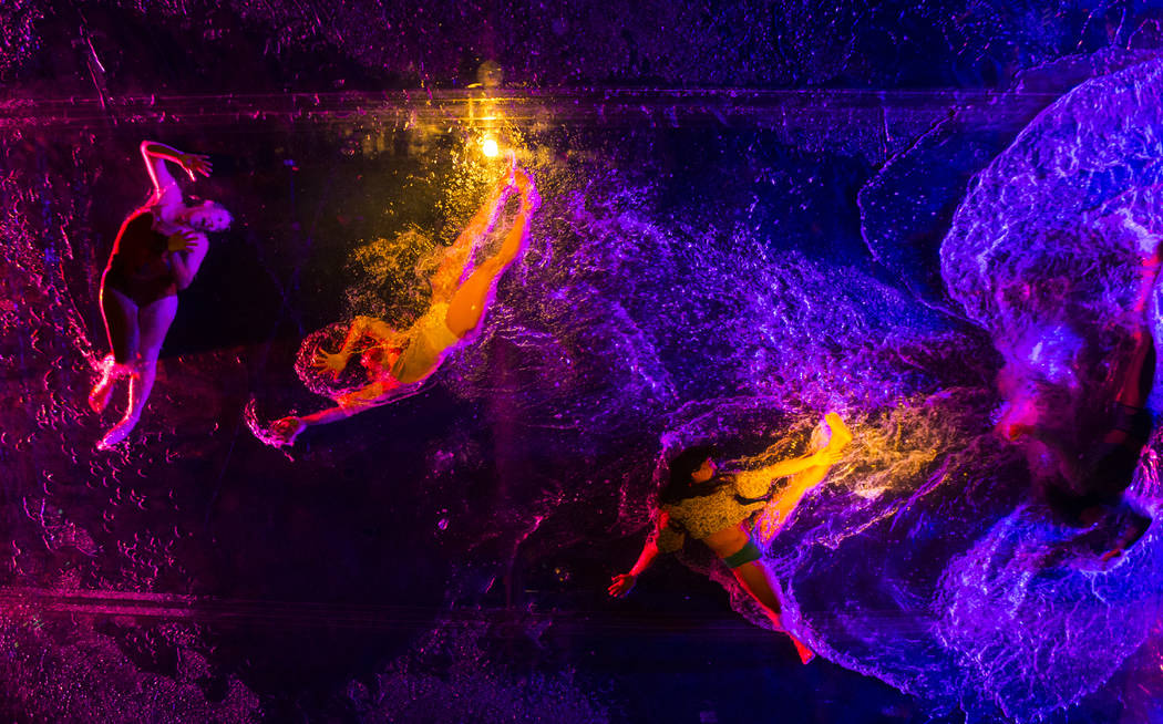 Cast members in "Fuerza Bruta" perform on a mylar suspended pool as part of a media preview at the show's tent outside of the Excalibur in Las Vegas on Wednesday, March 6, 2019. The show ...
