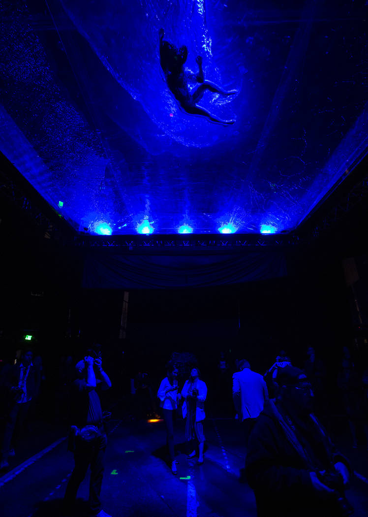 A cast members in "Fuerza Bruta" performs on a mylar suspended pool as part of a media preview at the show's tent outside of the Excalibur in Las Vegas on Wednesday, March 6, 2019. The s ...