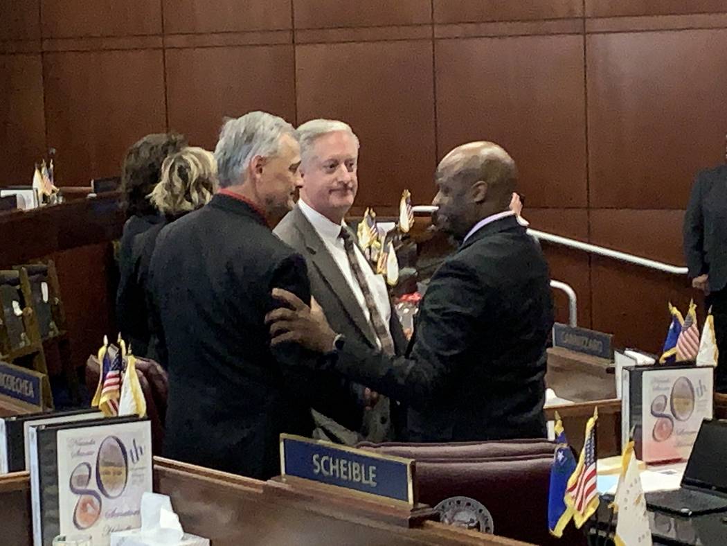 Nevada Senate Majority Leader Kelvin Atkinson, D-Las Vegas, at right, is greeted by GOP Senate Minority Leader James Settelmeyer, left, and GOP Sen. Keith Pickard on the Senate floor Tuesday, mome ...