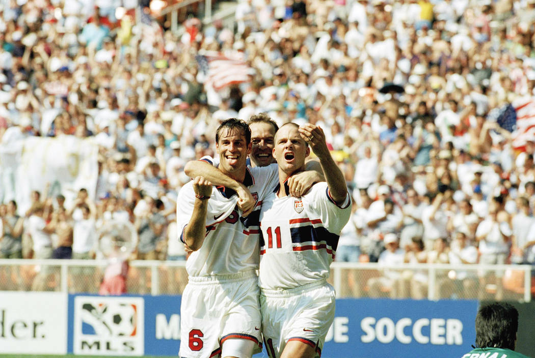 United States players, from left: midfielder John Harkes (6); midfielder Thomas Dooley (5); and foreward Eric Wynalda (11) celebrate Wynalda's goal during the first half of their game against Mexi ...