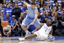 Duke's Zion Williamson (1) falls to the floor with an injury while chasing the ball with North Carolina's Luke Maye (32) during the first half of an NCAA college basketball game in Durham, N.C., W ...