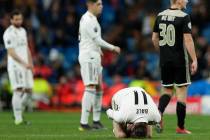 Real midfielder Gareth Bale reacts on the ground during the Champions League soccer match between Real Madrid and Ajax at the Santiago Bernabeu stadium in Madrid, Spain, Tuesday, March 5, 2019. (A ...