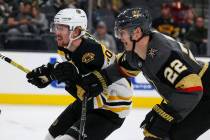 Boston Bruins center Joakim Nordstrom (20) and Vegas Golden Knights defenseman Nick Holden (22) move towards the puck during the second period of an NHL hockey game at T-Mobile Arena in Las Vegas, ...