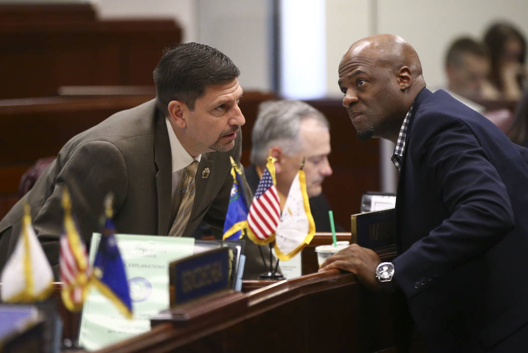 Sen. Mark Manendo, D-Las Vegas, left, talks with Sen. Kelvin Atkinson, D-North Las Vegas, during the second to last day of the Nevada Legislature at the Legislative Building in Carson City on Sund ...