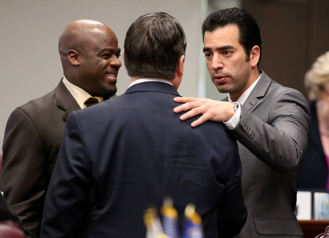 Nevada Senate Majority Leader Michael Roberson, R-Henderson, center, shakes hands with Senate Democrats Kelvin Atkinson, left, and Ruben Kihuen following the Senate's floor vote to approve Gov. Br ...