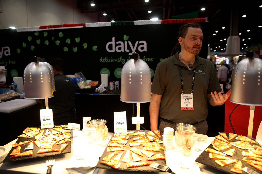 Chris Matthews of Daiya Foods of Canada talks to a reporter about his gluten-free and vegan pizza at the International Pizza Expo at the Las Vegas Convention Center Tuesday, March 5, 2019. (K.M. C ...