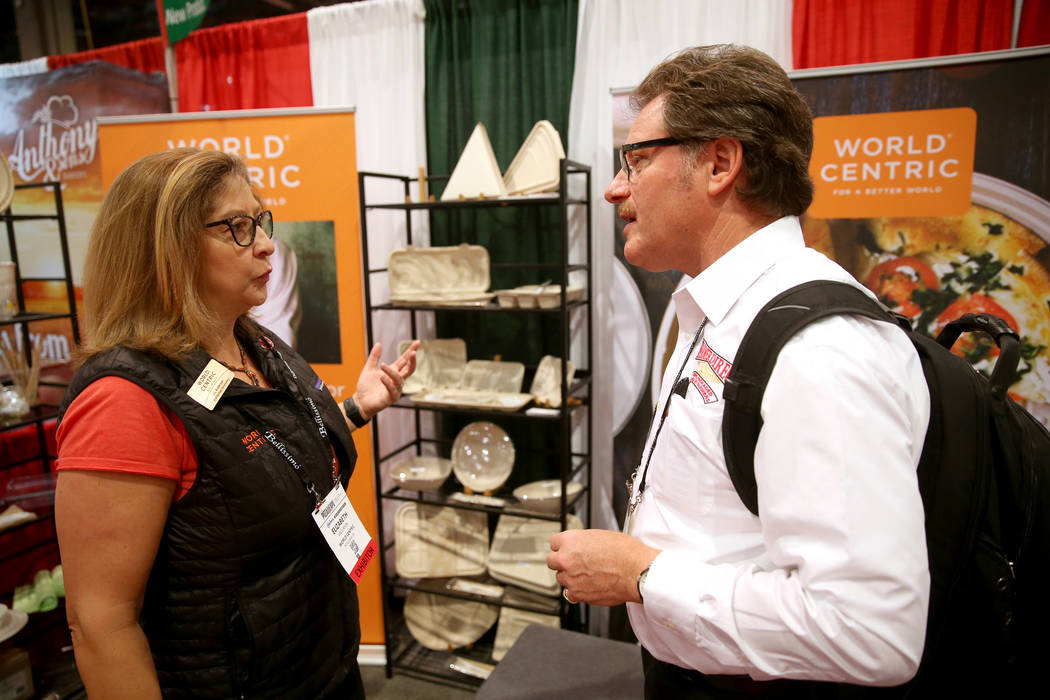 Liz Anderson, vice president of business development for World Centric, talks to Robert Morando of New Cambria, Kansas, in her booth at the International Pizza Expo at the Las Vegas Convention Cen ...