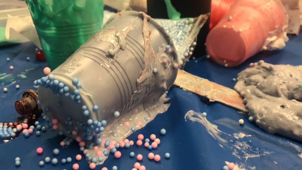 Library volunteers helped children and parents make slime. Glue, foam beads, slime and sticks covered the tables as the children toyed with the decorated goo in their hands. (Mia Sims-Las Vegas R ...