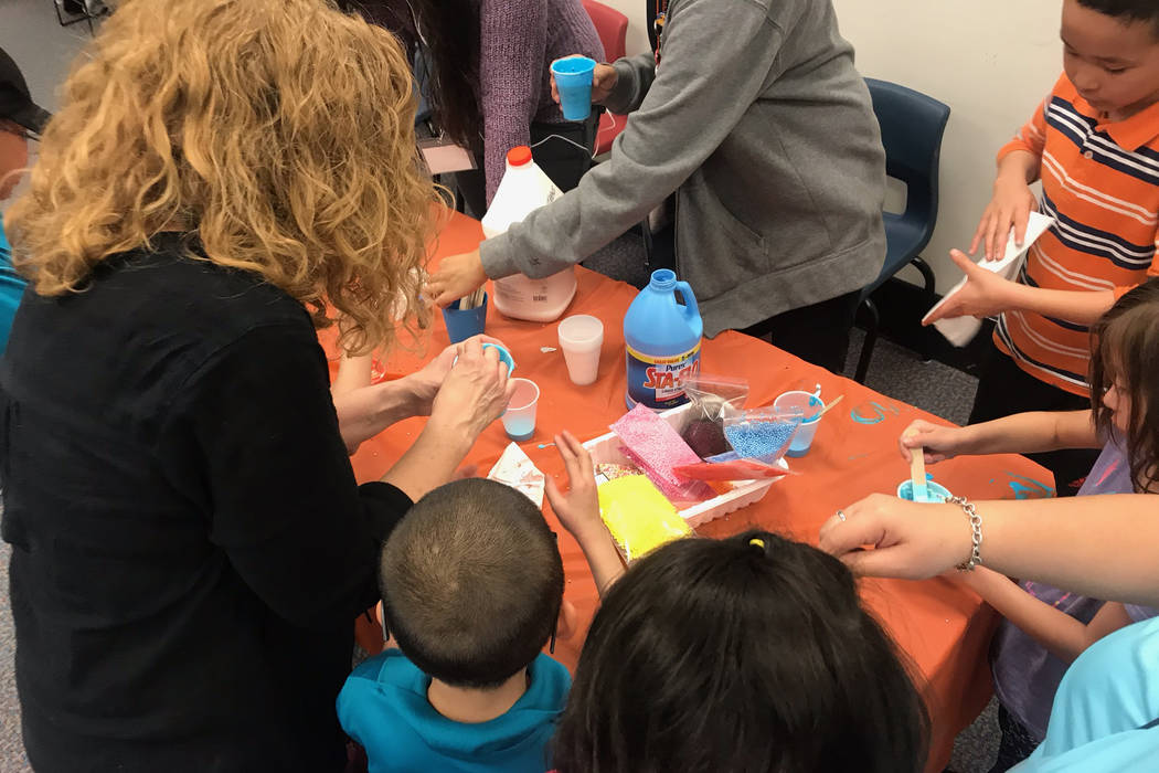 Attendees at the Gross World Records event help each other make slime after a presentation from Kathryn Tilton. (Mia Sims-Las Vegas Review-Journal/@miasims___)