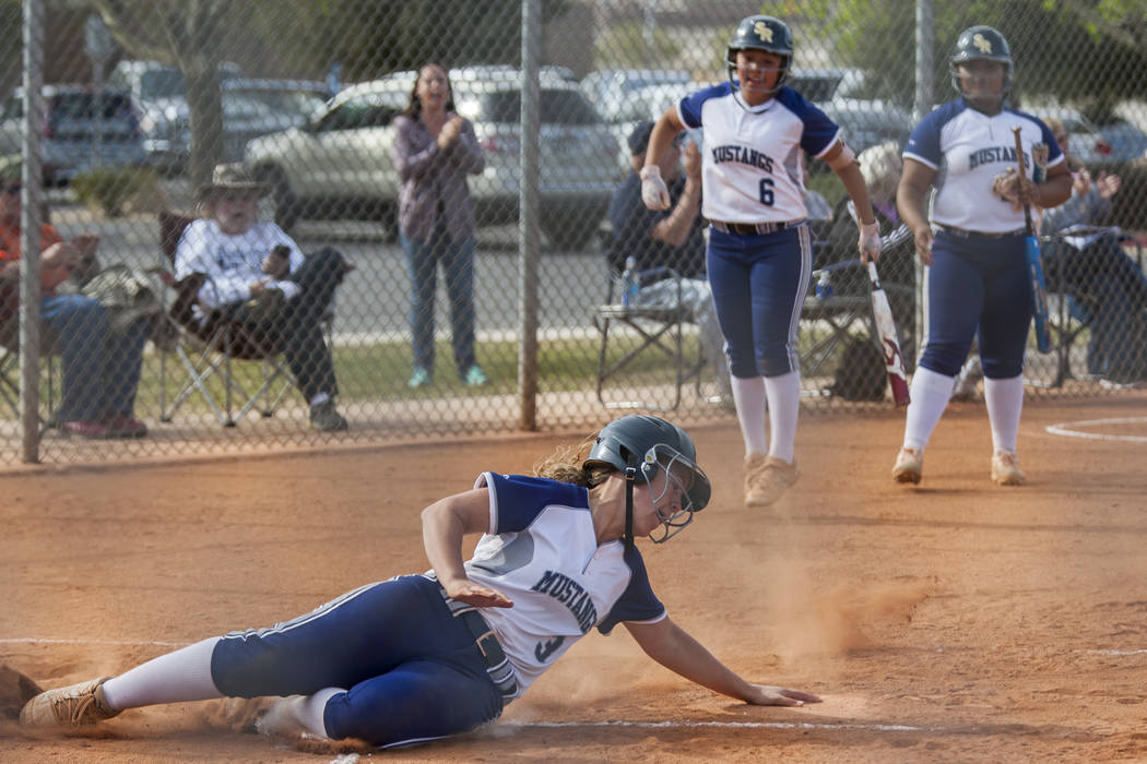 Shadow Ridge third baseman Caitlyn Covington slides into home base after a double and an error while playing against Palo Verde during the second inning at Shadow Ridge High School in Las Vegas on ...