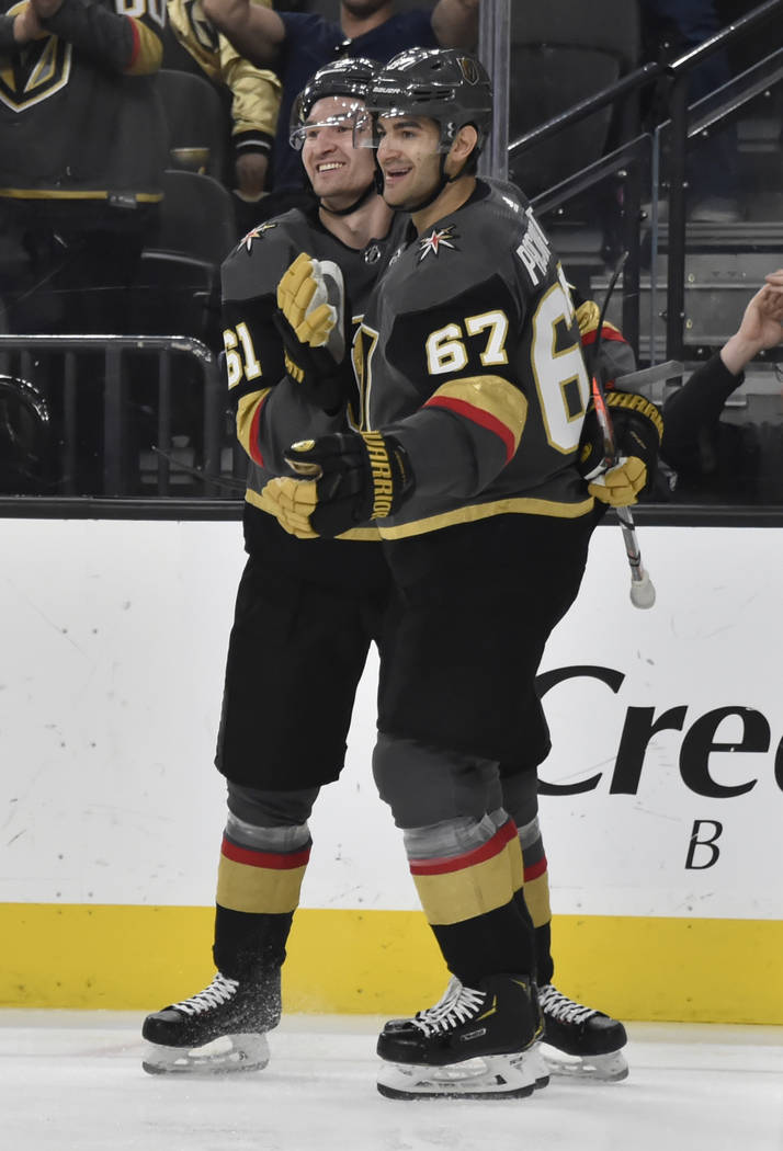 Vegas Golden Knights right wing Mark Stone (61) and left wing Max Pacioretty (67) celebrate Pacioretty's goal against the Vancouver Canucks during the second period of an NHL hockey game Sunday, M ...