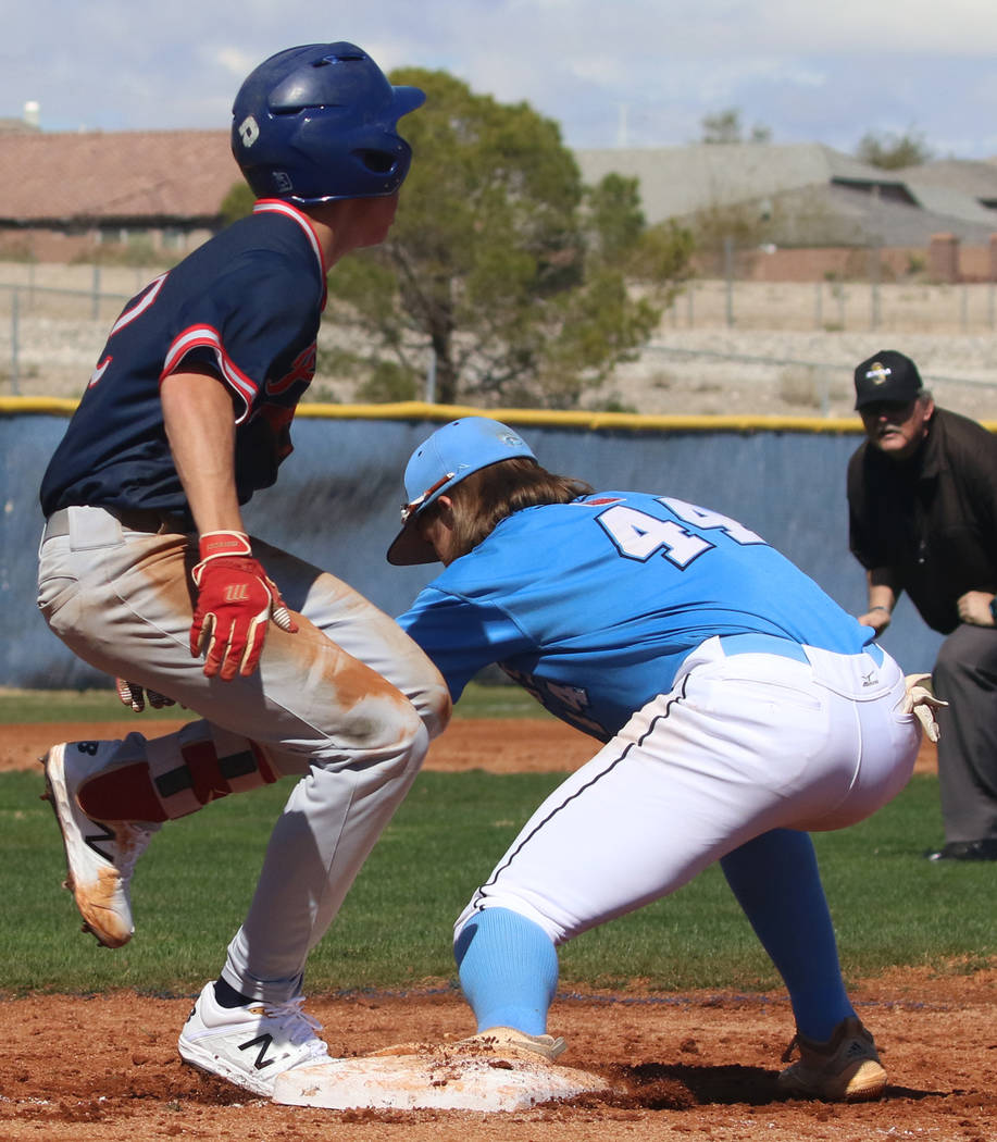 Centennial's third baseman Kris Bow (44) tags Liberty's Jack Hale during their baseball game at Centennial High School on Thursday, March 7, 2019, in Las Vegas. Centennial won 5-4. (Bizuayehu Tesf ...