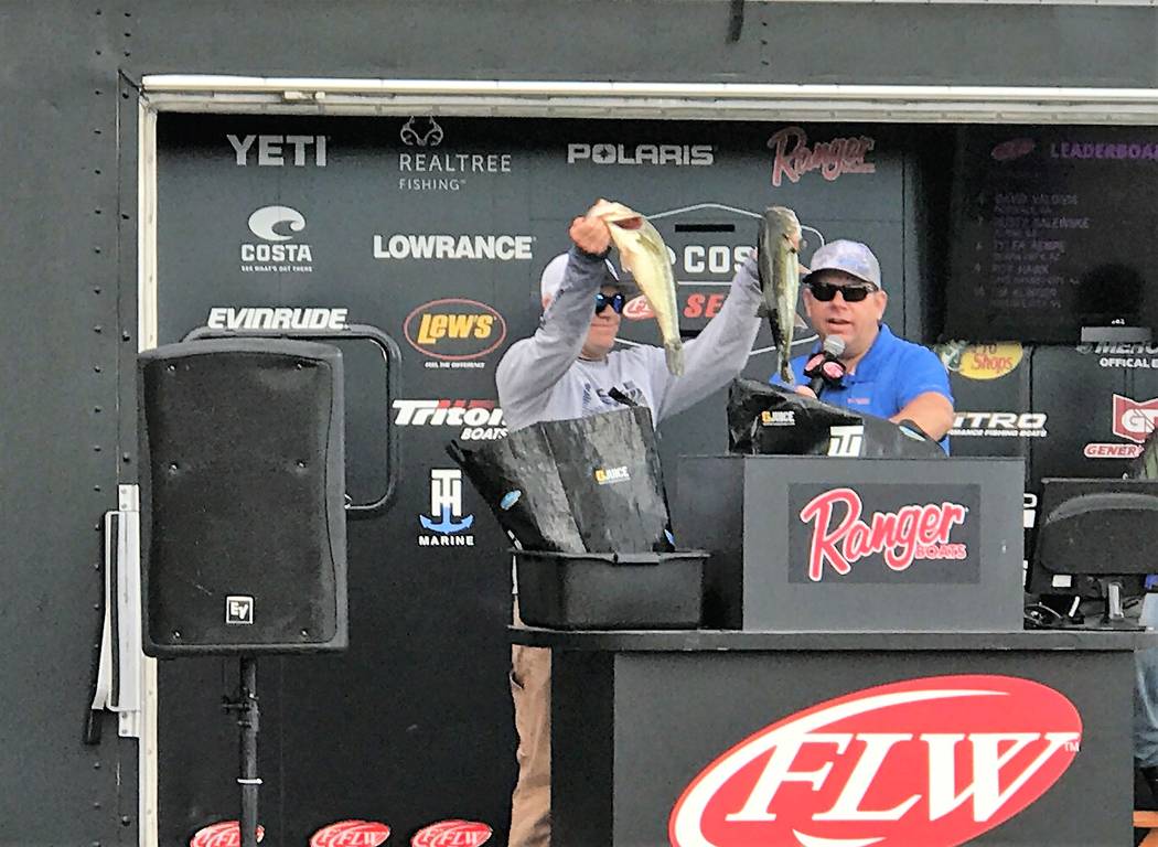 Tim Klinger, of Boulder City, holds up two of the five bass that brought his tournament total to 34-pounds, 12-ounces and gave him the victory on Championship Saturday of the Costa FLW Series West ...