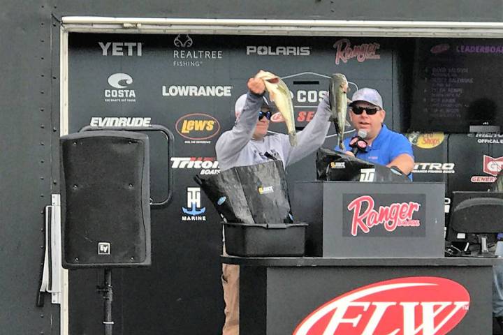 Tim Klinger, of Boulder City, holds up two of the five bass that brought his tournament total to 34-pounds, 12-ounces and gave him the victory on Championship Saturday of the Costa FLW Series West ...