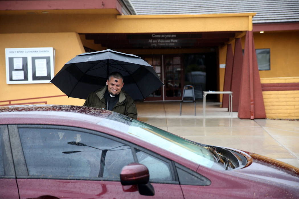 Pastor Jeremy Nausin talks to a driver at Holy Spirit Lutheran Church during an "Ashes to Go" drive-thru Ash Wednesday blessing at the Las Vegas church, Wednesday, March 6, 2019. (K.M. Cannon/Las ...