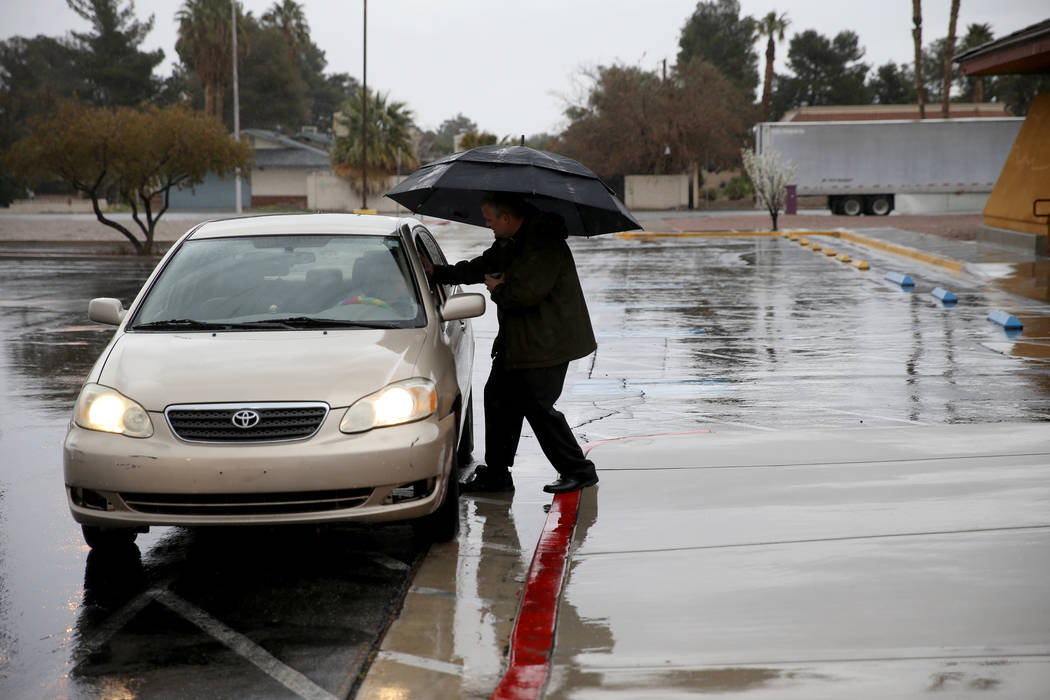 Pastor Jeremy Nausin applies ashes to a driver at Holy Spirit Lutheran Church during an "Ashes to Go" drive-thru Ash Wednesday blessing at the Las Vegas church Wednesday, March 6, 2019. (K.M. Cann ...