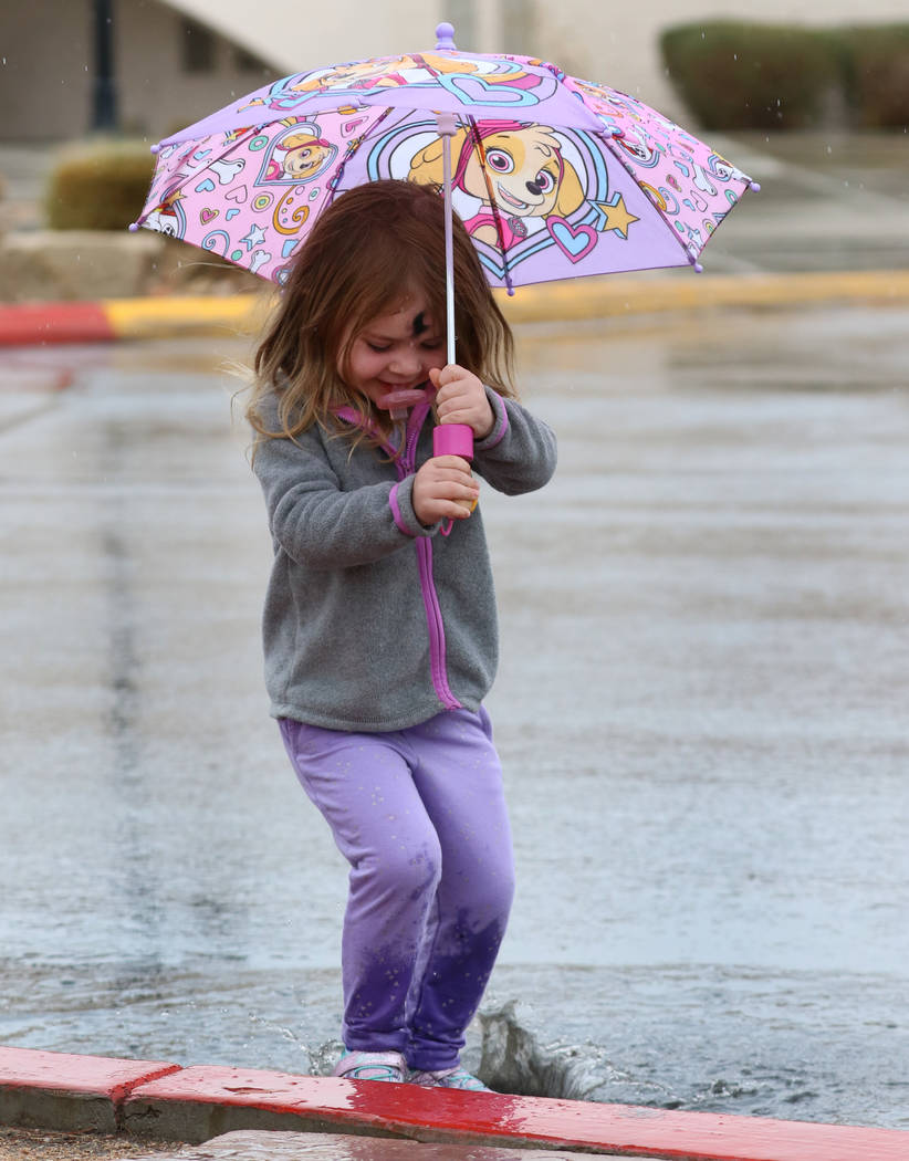 Kaisyn Wood, 3, of Las Vegas plays in puddle during the rain on Wednesday, March. 6, 2019, in Las Vegas. (Bizuayehu Tesfaye/Las Vegas Review-Journal) @bizutesfaye