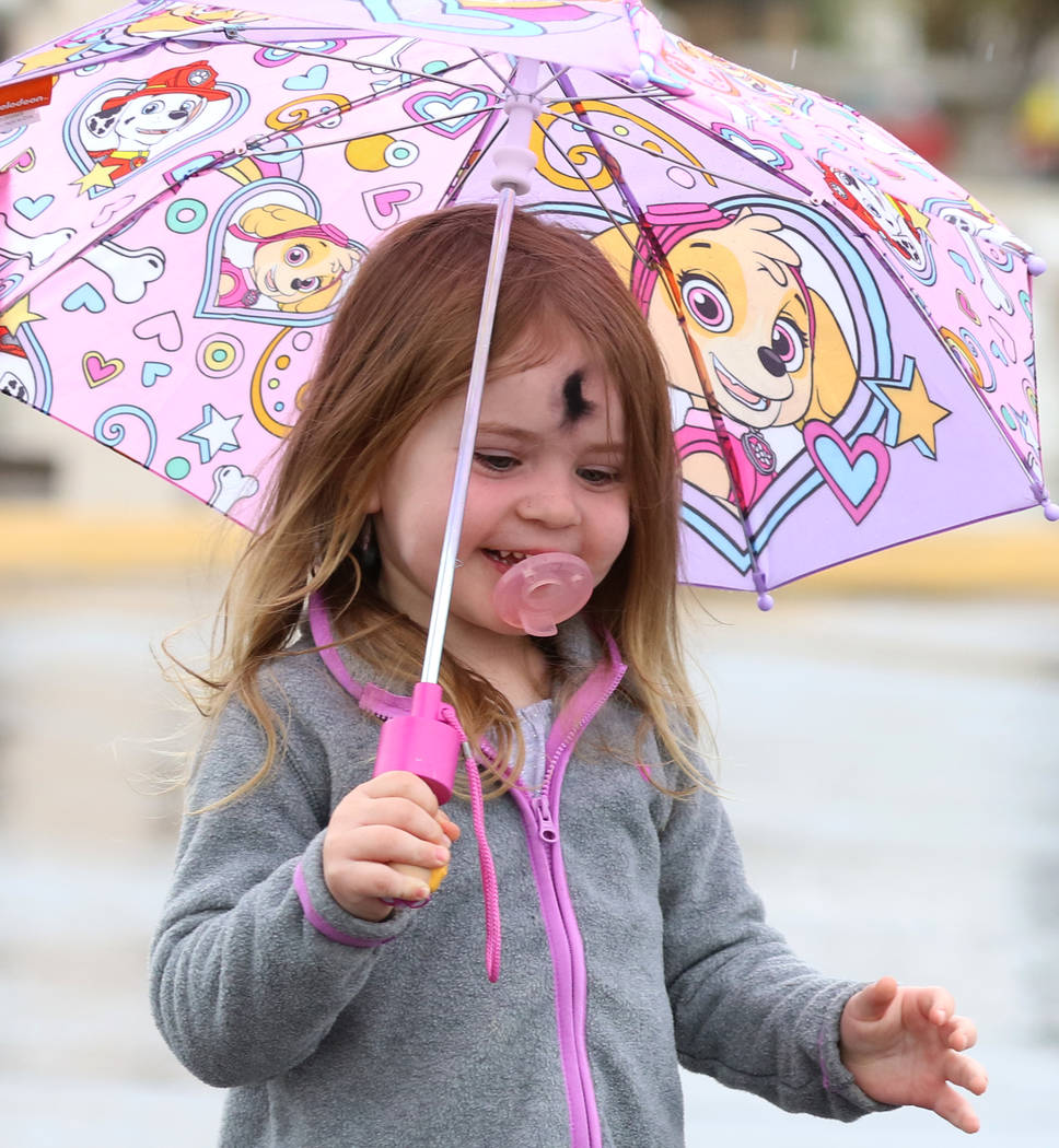 Kaisyn Wood, 3, of Las Vegas holds an umbrella to protect herself from rain on Wednesday, March. 6, 2019, in Las Vegas. (Bizuayehu Tesfaye/Las Vegas Review-Journal) @bizutesfaye