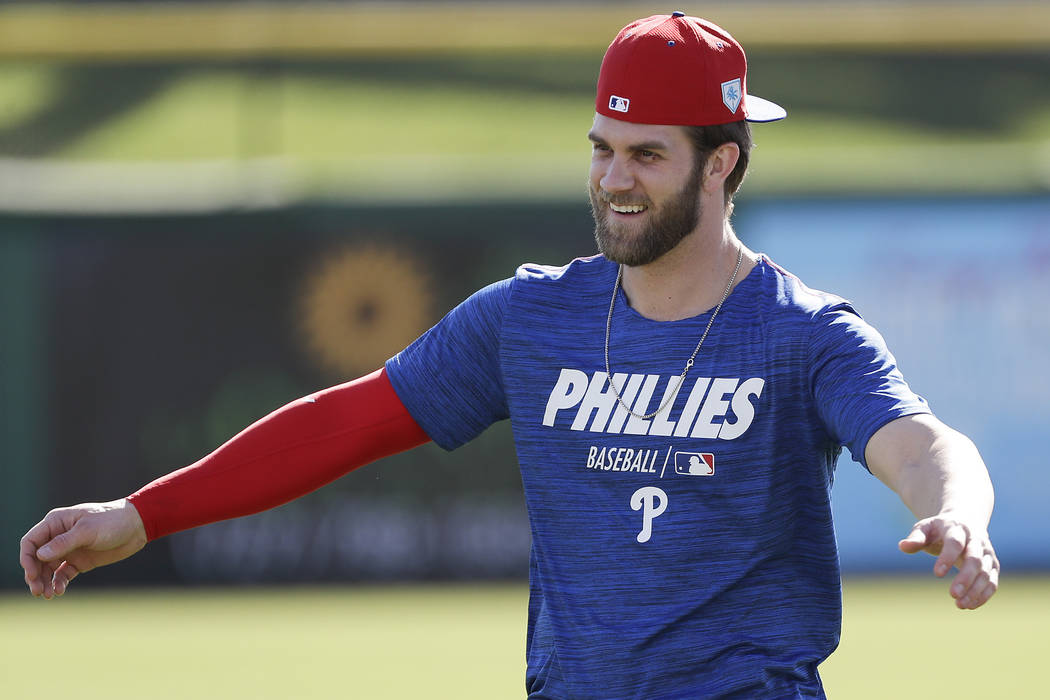 Philadelphia Phillies outfielder Bryce Harper warms up during baseball practice Sunday, March 3, 2019, at Spectrum Field in Clearwater, Fla. (Yong Kim/The Philadelphia Inquirer via AP)