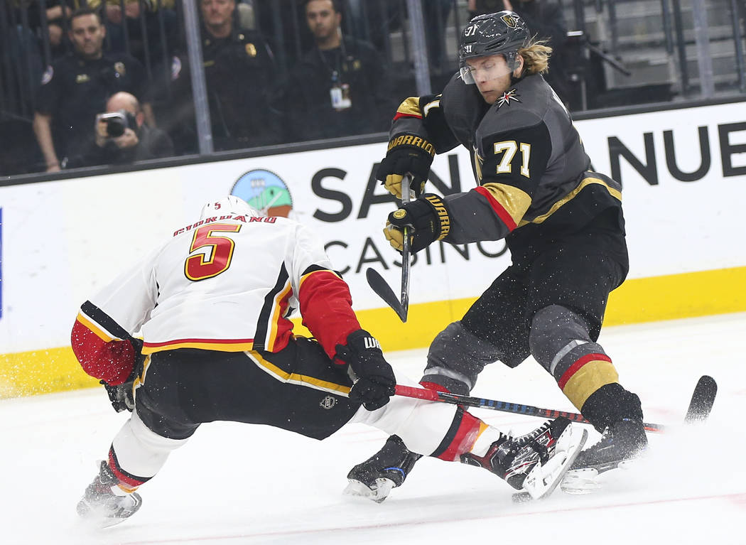 Calgary Flames defenseman Mark Giordano (5) stretches out to block the puck with his skate against Golden Knights center William Karlsson (71) during the first period of an NHL hockey game at T-Mo ...