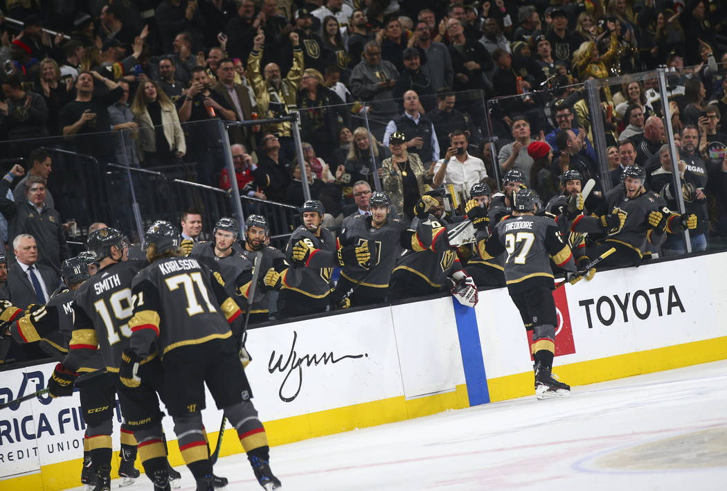 Golden Knights defenseman Shea Theodore (27) celebrates his goal with the bench during the first period of an NHL hockey game against the Calgary Flames at T-Mobile Arena in Las Vegas on Wednesday ...