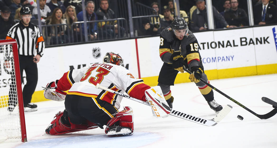 Calgary Flames goaltender David Rittich (33) blocks the puck in front of Golden Knights right wing Reilly Smith (19) during the first period of an NHL hockey game at T-Mobile Arena in Las Vegas on ...