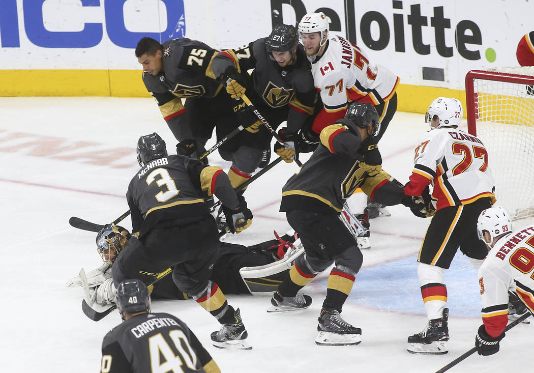Golden Knights goaltender Marc-Andre Fleury dives to stop the puck during the third period of an NHL hockey game against the Calgary Flames at T-Mobile Arena in Las Vegas on Wednesday, March 6, 20 ...