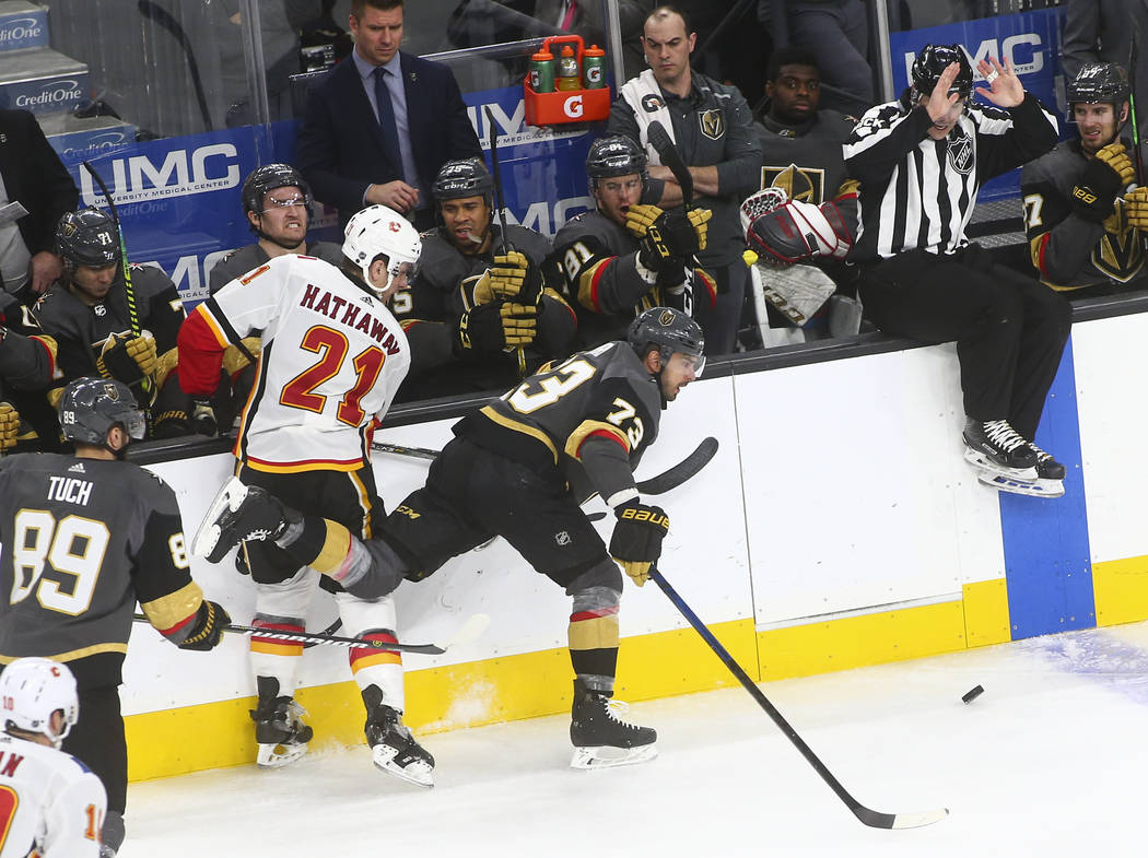 Golden Knights center Brandon Pirri (73) chases after the puck past Calgary Flames right wing Garnet Hathaway (21) during the third period of an NHL hockey game at T-Mobile Arena in Las Vegas on W ...