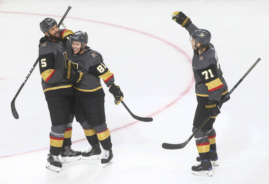 Golden Knights defenseman Deryk Engelland (5) celebrates his goal with Jonathan Marchessault (81) and William Karlsson (71) during the third period of an NHL hockey game against the Calgary Flames ...