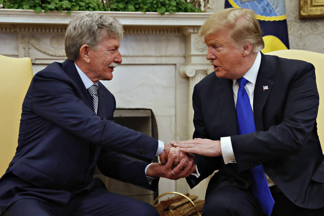 President Donald Trump, right, shakes hands with Danny Burch, a former U.S. hostage held in Yemen, Wednesday, March 6, 2019, in the Oval Office of the White House in Washington. (AP Photo/Jacquely ...