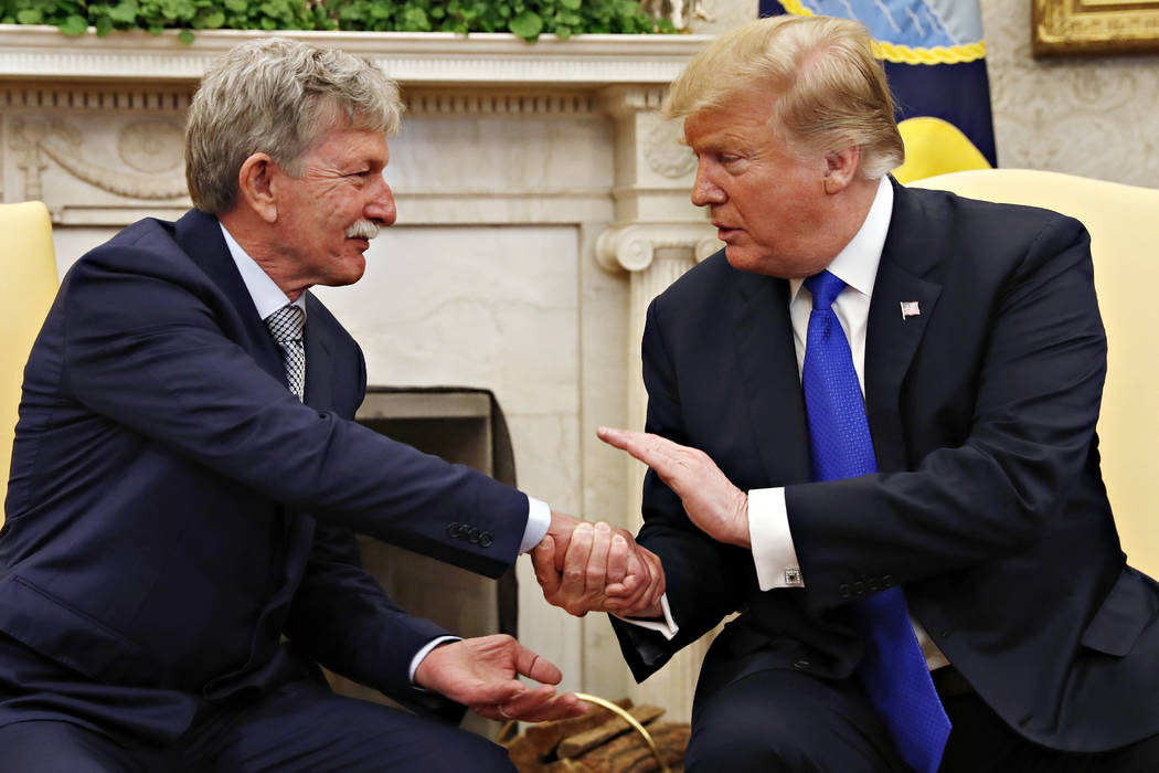 President Donald Trump, right, shakes hands with former U.S. hostage in Yemen, Danny Burch, Wednesday, March 6, 2019, in the Oval Office of the White House in Washington. (AP Photo/Jacquelyn Martin)