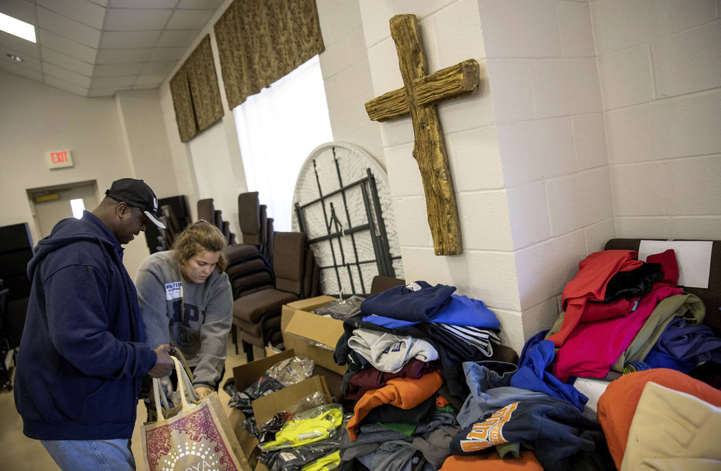 Volunteer Anna Tepool, right, helps tornado victim James Johnson, with items at a donation distribution site at Providence Baptist Church in Opelika, Ala., Wednesday, March 6, 2019. (AP Photo/Davi ...