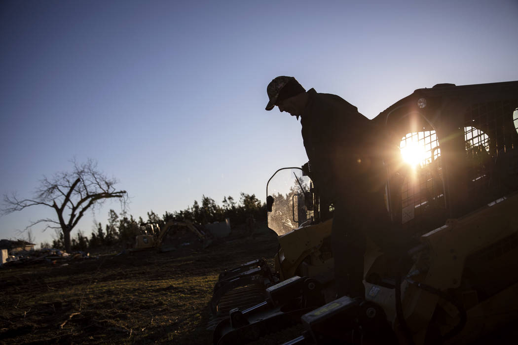 Tim Walters starts up equipment to clear debris while helping home owners whose house was destroyed by a tornado in Beauregard, Ala., Wednesday, March 6, 2019. (AP Photo/David Goldman)