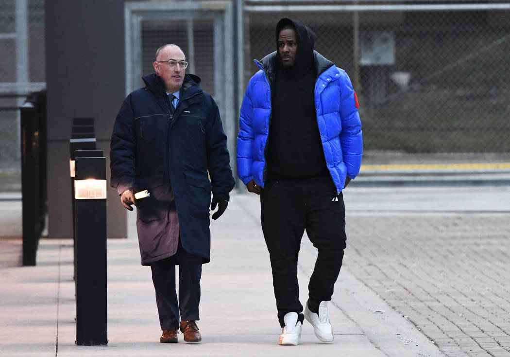 FILE - In this Monday, Feb. 25, 2019 file photo, R. Kelly, right, leaves Cook County Jail with his defense attorney, Steve Greenberg, in Chicago. In his first interview since being charged with se ...