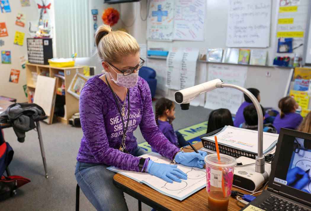 Nikki McGuire shows her kindergarten students some images projecting on the screen and asking them questions during a class at Staton Elementary School in Las Vegas, Tuesday, March 5, 2019. Every ...