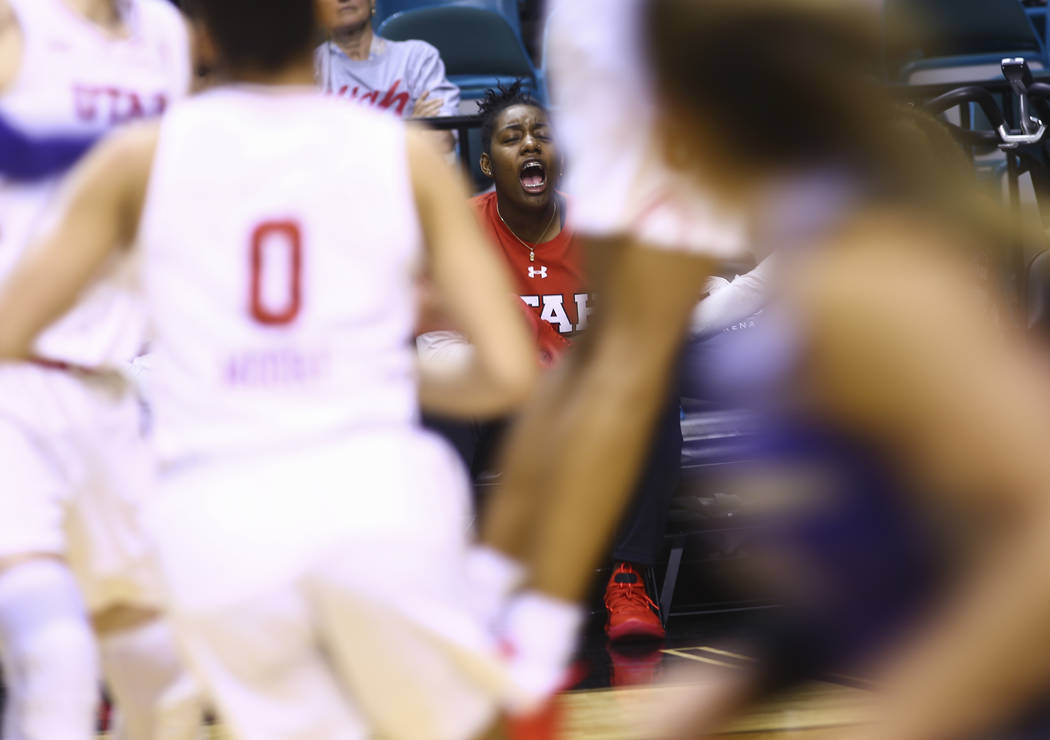 Former Liberty basketball player Dre'Una Edwards, who now plays for Utah, cheers her team on as they play Washington during the Pac-12 women's basketball tournament at the MGM Grand Garden Arena i ...