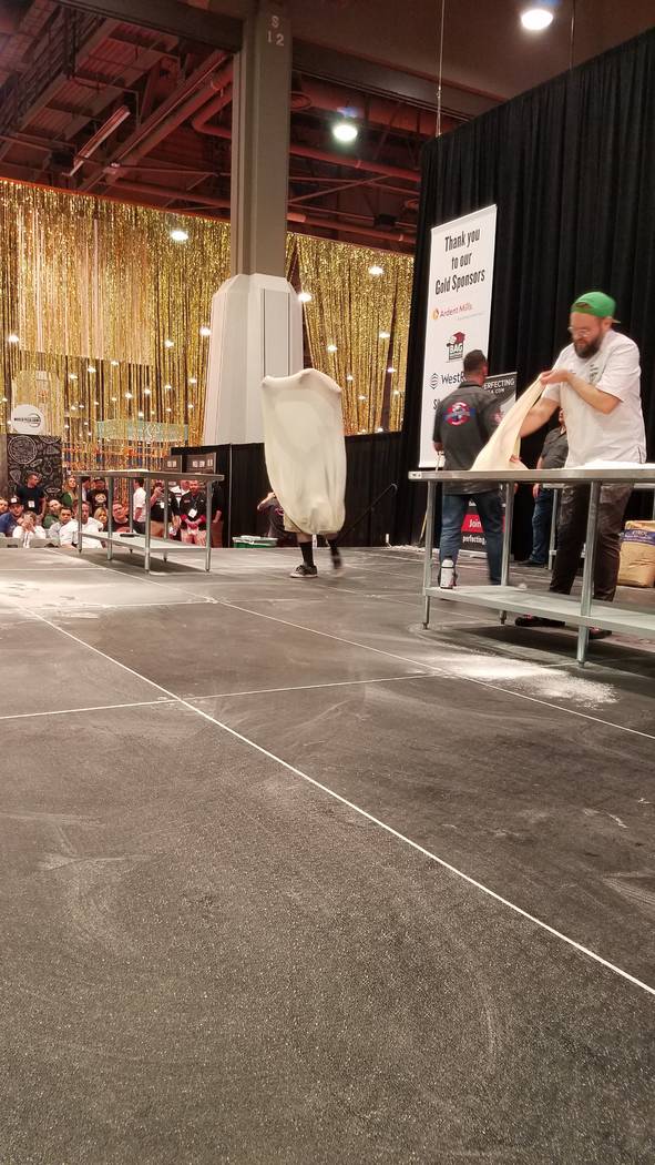 Nathan Wilson (left), winner of the Largest Stretch competition contest at the International Pizza Expo on Wednesday, March 6, 2019, at the Las Vegas Convention Center. Heidi Knapp Rinella/Las Veg ...