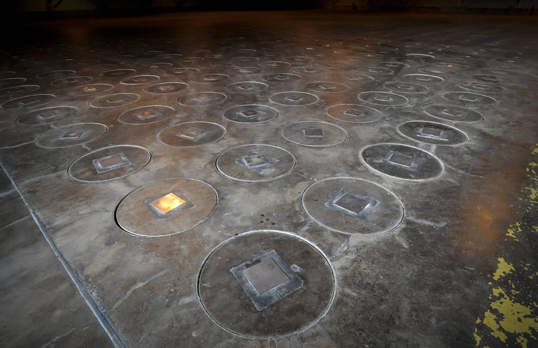 Radioactive waste sealed in large stainless steel canisters is stored under five feet of concrete in a storage building at the Savannah River Site near Aiken, S.C., Nov. 20, 2013. (Stephen B. Mort ...