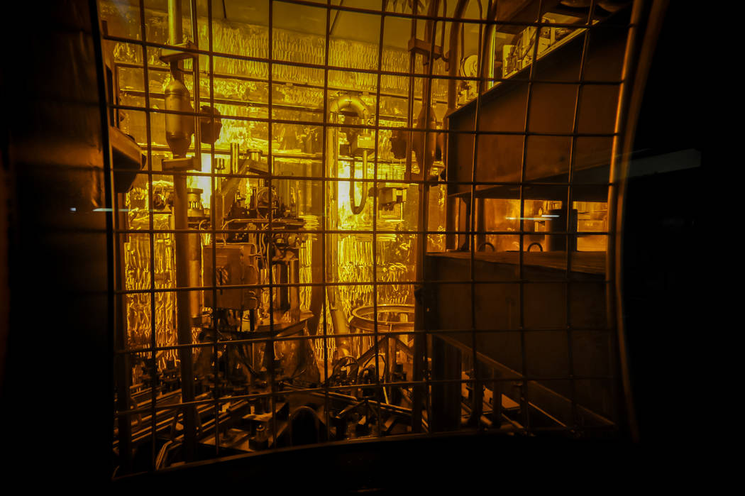 In this Nov. 20, 2013 photo, seen through thick protective glass, shows the area where workers sand-blast the large stainless steel tanks used in the vitrification process to rid them of contamina ...
