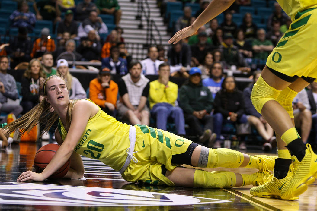Oregon Ducks guard Sabrina Ionescu (20) falls down wit the ball during the second half of an NCAA college basketball game at the Pac-12 women's tournament at the MGM Grand Garden Arena in Las Vega ...
